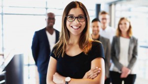 White female executive standing with arms crossed