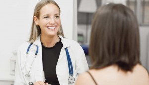 Female doctor explaining diagnosis to her young woman patient.