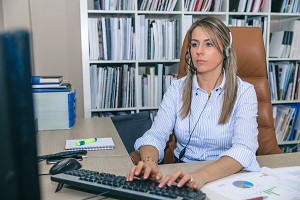 Blonde secretary working with computer in office