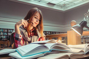 Successful Girl Studying Hard in Library