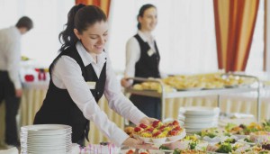 Restaurant waitress serving table with food