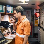 Marine Engineer working on radio communication at Engine Control room